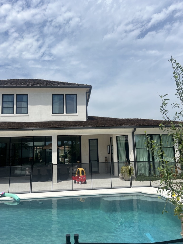 Modern house with backyard swimming pool and patio