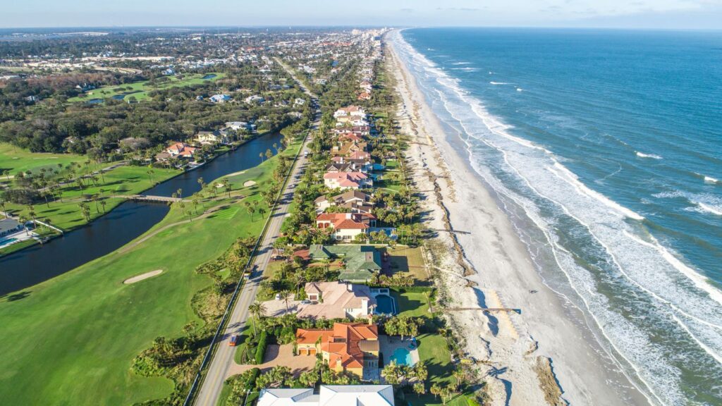 Aerial view of coastal homes and beach shoreline