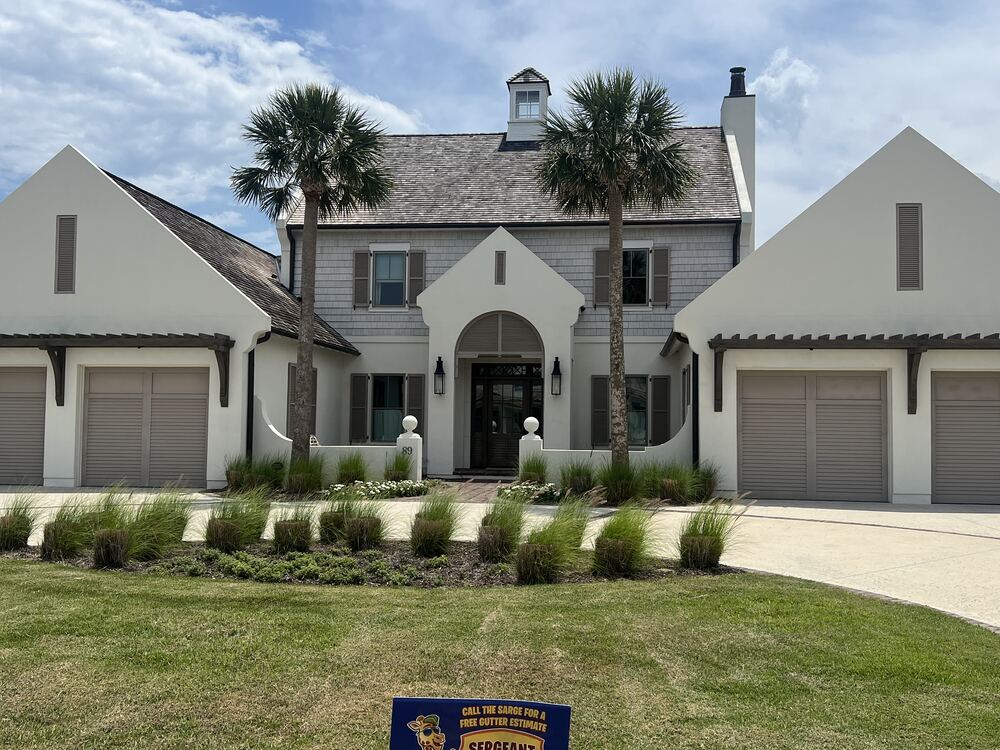Seamless gutter installation across multiple gables on a Jacksonville area farmhouse